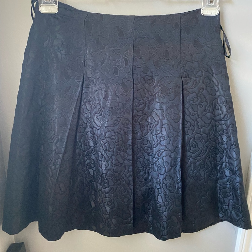 Black pleated a line skirt .. shiny fabric.. nice for  the office, parties etc..